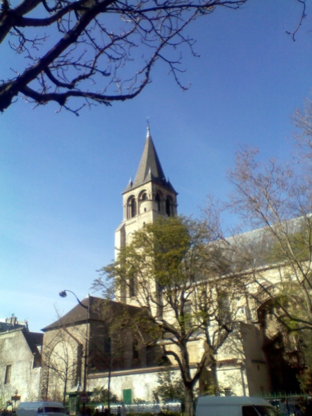 View of the steeple and main building of the Église de Saint-Germain-des-Prés through trees